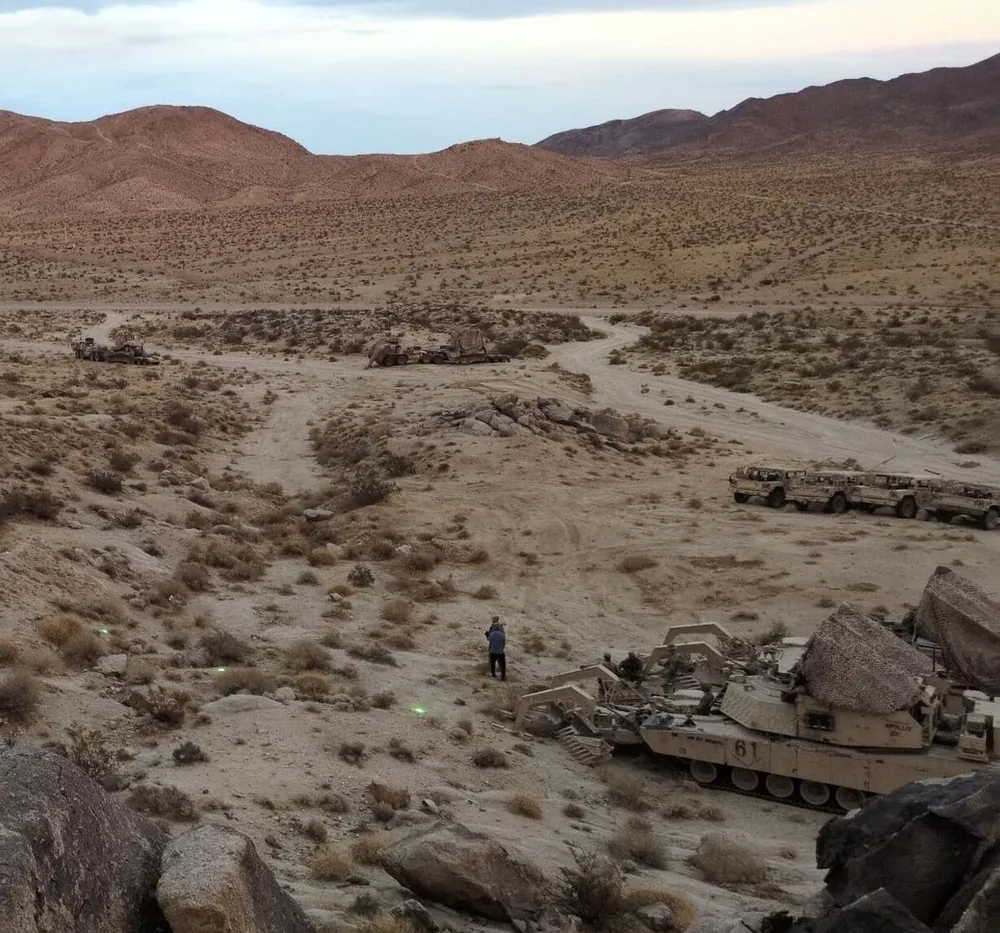 BreachON markers visible as green dots in desert at dusk beside breach vehicle